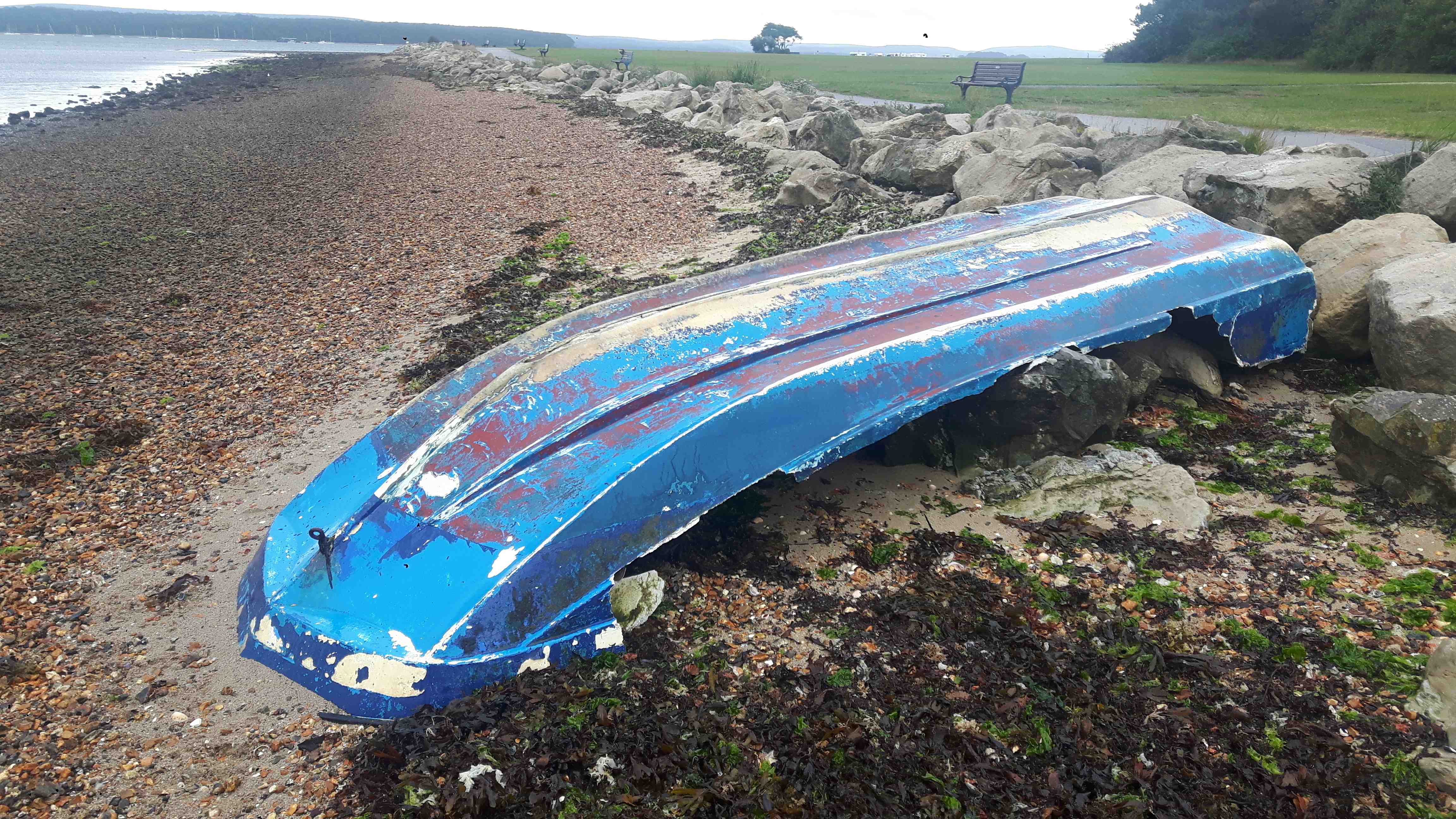 Derelict glass fibre (GRP) boat near Poole Quay, Poole Harbour, Sept 2022